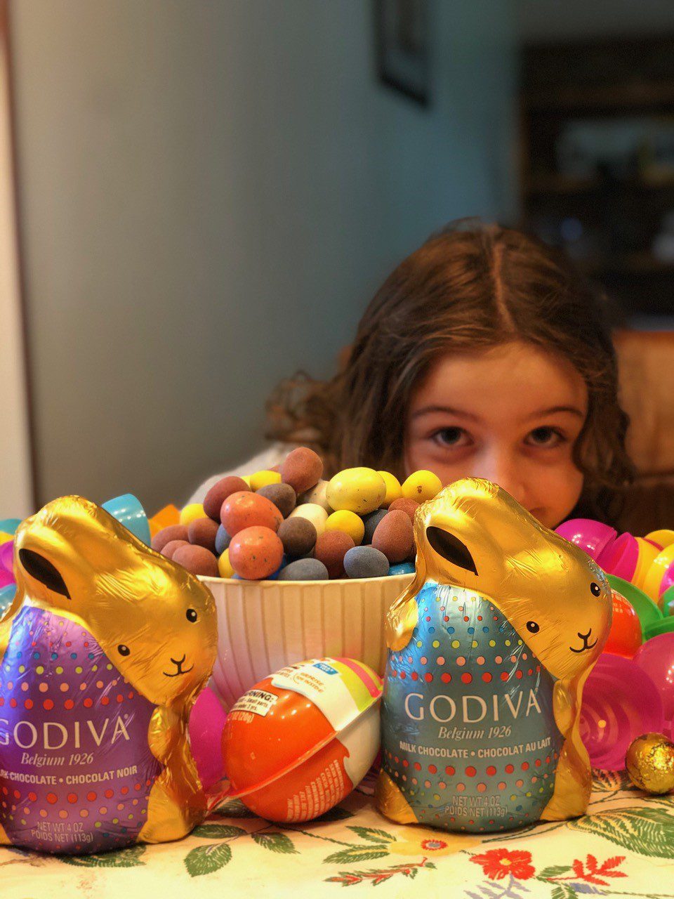 A girl with some chocolate bunnies and fruit